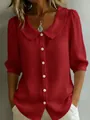 Detail of red linen-texture blouse with Peter Pan collar and white button closure - S / Red