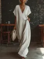 Detail view of an elegant V-neck linen maxi dress with delicate lace trim embroidery - S / Dresses / White