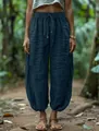 Close-up of loose dark blue lantern pants featuring an elastic drawstring waist design - S / Bottoms / Aqua