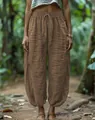 Relaxed brown linen-textured lantern pants with elastic drawstring waist shown on model - S / Bottoms / Coffee