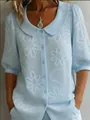 Elegant light blue short-sleeved button-down shirt featuring delicate white daisy embroidery - S / Tops / Light Blue