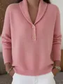 Close-up of pink knitted sweater showing buttoned polo collar and ribbed texture - Pink