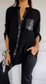 Detail view of black long sleeve shirt with sequined pocket and placket - Black