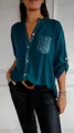 Detailed shot of teal sequin pocket and placket on elegant loose fit long sleeve shirt - Green