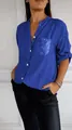 Detail of a bright blue women's shirt with sequined pocket and sparkling button placket. - Dark Blue