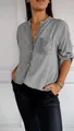 Detail of a grey long-sleeve casual shirt featuring a shimmering sequin-embellished pocket. - Gray