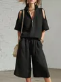 Vista detallada del conjunto negro de dos piezas con top de hombros descubiertos y shorts. - S / Top Y Pantalón / Negro