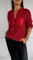 Close-up detail of women's red casual long sleeve shirt with sequins pocket and button-down trim - Red