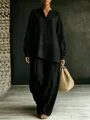 Full view of a woman wearing a black loose linen long-sleeve two-piece set with a woven bag - S / Top And Bottom / Black