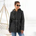 Stylish women's black mid-length winter parka featuring a faux fur hood and waist belt detail - M / Tops / Black