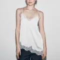Elegant white silk-like camisole top featuring unique asymmetrical lace trim detail - XS / Tops / White