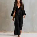 Elegant bohemian black long-sleeve jumpsuit featuring a deep V-neck and elastic waist - XS / Jumpsuits / Black