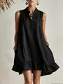 Detailed view of a black sleeveless linen-texture dress with a ruffle hem and pockets. - Black