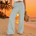Detail view of vertical striped wide-leg pants with a smocked high waist for beach - Light Green Stripes