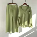 Detailed shot of a green linen two-piece set featuring a long-sleeved shirt and pants - S / Top And Bottom / Grass Green