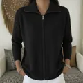 Close-up of a stylish black zip-up knitted cardigan with a ribbed collar and cuffs - S / Tops / Black