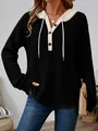 Women's black loose-fit knit hoodie with buttons and cream contrast trim. - Black