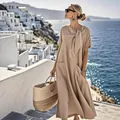 Vue détaillée d'une robe longue kaki fluide avec nœud au col et poches pratiques - S / Robes / Kaki