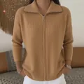 High-quality close-up of a camel zip-up knit cardigan sweater with elegant ribbed texture - Camel