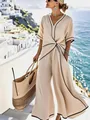 Detail view of elegant beige jumpsuit with black piping and twisted waist design - S / Set / Apricot