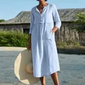 Casual light blue cotton linen dress with buttons and pockets shown on a model. - S / Dresses / Light Blue