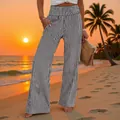 Detail view of stylish high-waisted striped wide-leg trousers at a tropical beach sunset - Grey Stripe