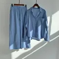 Detail of vintage light blue cotton linen long-sleeve shirt and wide-leg trousers set - Blue