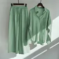 Detailed view of women's mint green cotton linen set under natural light and shadow - Emerald Green