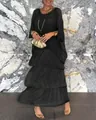 Chic black chiffon tiered maxi dress featuring batwing sleeves and a round neckline on model - S / Dresses / Black
