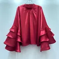 Detail view of red satin blouse featuring tiered ruffled bell sleeves and mock neck - S / Tops / Red