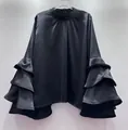 Detailed view of elegant black satin blouse featuring chic tiered ruffle bell sleeves. - S / Tops / Black