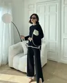 Elegant black two-piece knit set featuring white contrast trim and wide-leg trousers - One Size / Top And Bottom / Black