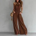 Close-up detail of smocked waist and pockets on a brown bohemian wide-leg jumpsuit - S / Dresses / Dark Brown