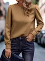 Close-up view of the quilted texture and bubble sleeve detail on the camel sweatshirt - S / Tops / Coffee