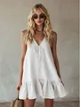 Elegant white V-neck sleeveless ruffle dress with a bow tie detail for retro summer vacations. - White