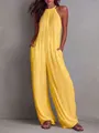 Dettaglio di una tuta intera gialla a pieghe con scollo all'americana e gamba larga da mare. - Taglia S / Set / Giallo