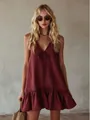 Detailed view of wine red V-neck sleeveless dress with ruffled hem and bow tie detail - S / Dresses / Burgundy