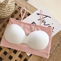 Close-up detail of a pink ribbed seamless bandeau bra with white comfort padding - Tops / One Size / Pink