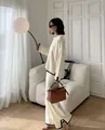 Elegant cream two-piece knitwear set featuring black contrast trim and wide leg pants - One Size / Top And Bottom / Apricot