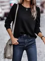Detail view of black quilted sweatshirt featuring elegant puff sleeves and round neck - S / Tops / Black
