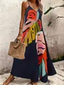 Vista detallada de un vestido largo bohemio azul marino con un gran estampado de hojas tropicales. - Arcoíris