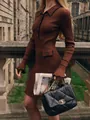 Detailed view of a brown ribbed knit dress with contrast black trim and an elegant polo collar - S / Dresses / Mini Coffee