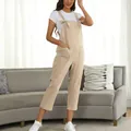 Casual beige cotton overalls for women in a comfortable loose fit with large pockets. - S / Jumpsuits / Apricot