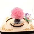 Close-up of a decorative pink resin crystal money tree on an engraved circular wooden base - 5cm*4.2cm / Treated Rose Quartz