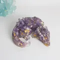 Detailed close-up of a handmade amethyst resin dragon figurine decorated with gold leaf flakes - Amethyst + Gold Foil
