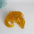 Detailed view of an amber translucent resin dragon figurine with crystalline texture - Citrine + Gold Foil