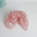 Macro detail view of pink resin dragon figurine with rose quartz chips and gold flakes - Rose Quartz