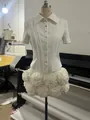 Detailed view of an elegant white slim-fit short-sleeved shirt and 3D floral mini skirt set. - XS / Top And Bottom / White