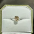 Detailed close-up view of a 2ct oval champagne moissanite ring in silver pavé setting - US Size 5 / 2ct Full Moissanite