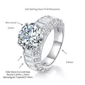 Detailed technical view of a 5 carat round moissanite ring with baguette diamond accents - US Size 5 / Silver